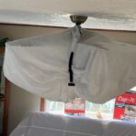 Chandelier wrapped with dust-resistant fixture cover